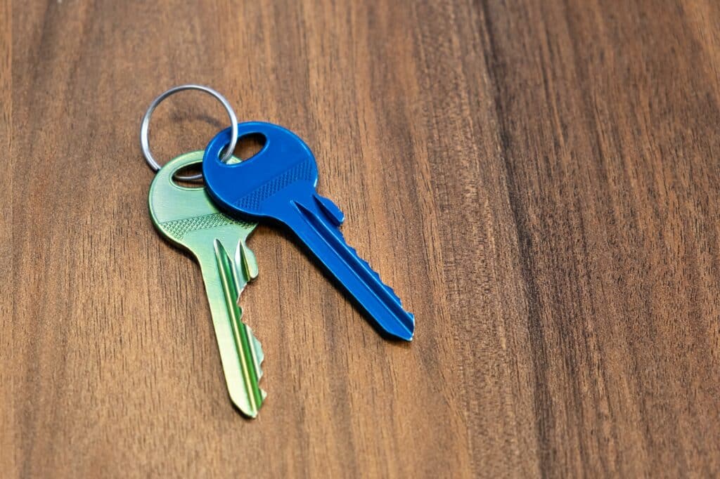 keys on wooden table background. rent sell buy apartment estate business